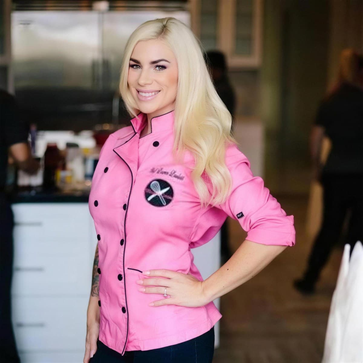 Chef Lauren Lawless in her pink chef coat, smiling in a home kitchen