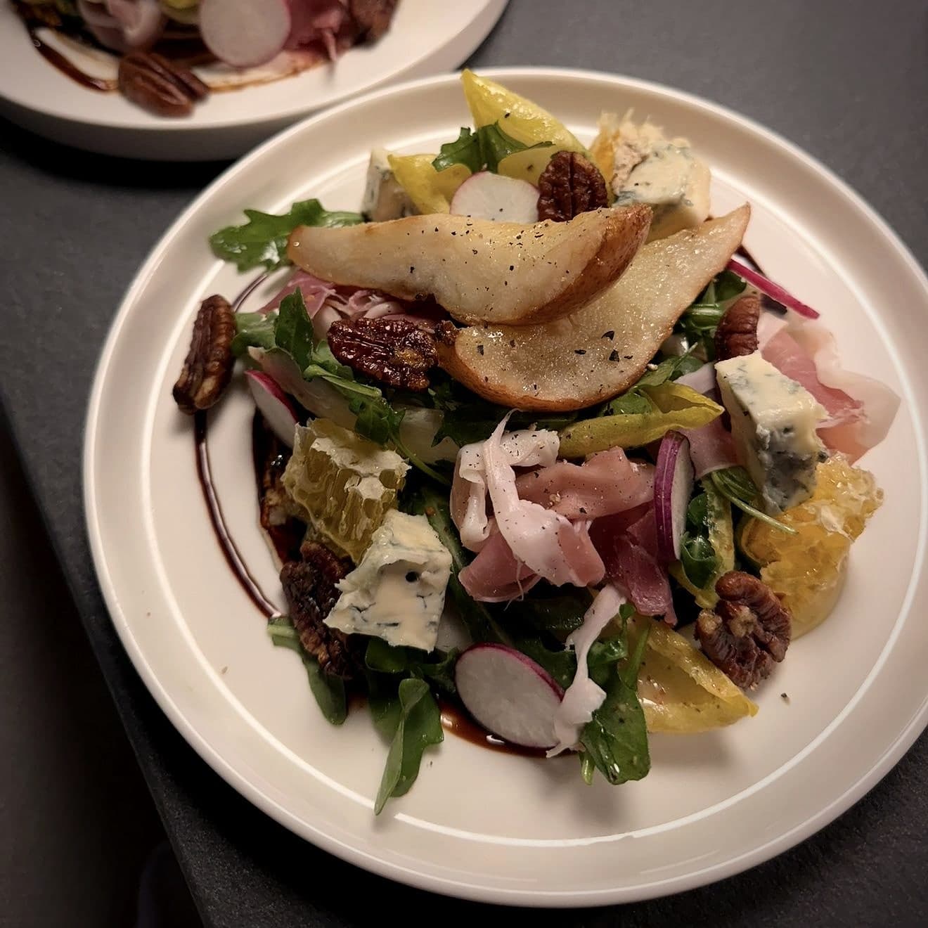 Chef Lauren Lawless's arugula salad with roasted pear, blue cheese, prosciutto, candied pecans and honeycomb
